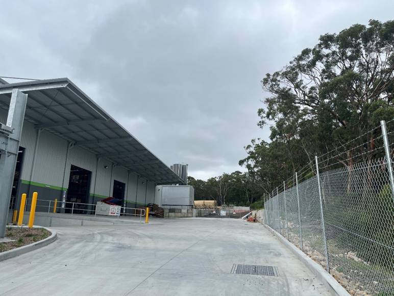 A building with a fence and trees

AI-generated content may be incorrect.