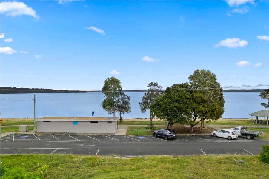 A parking lot next to a body of water

AI-generated content may be incorrect.