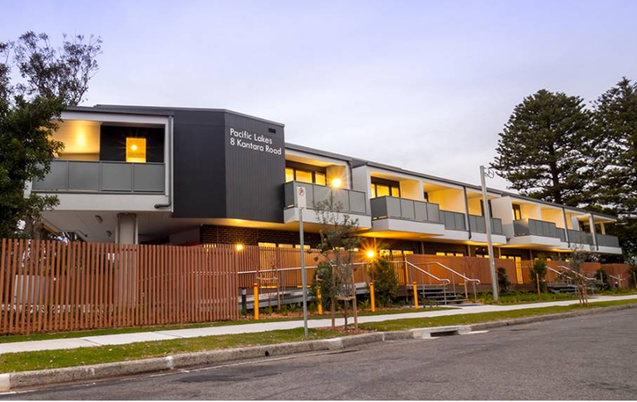 A building with a fence and trees

AI-generated content may be incorrect.